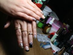 Dłonie z pomalowanymi paznokciami i akcesoriami do manicure